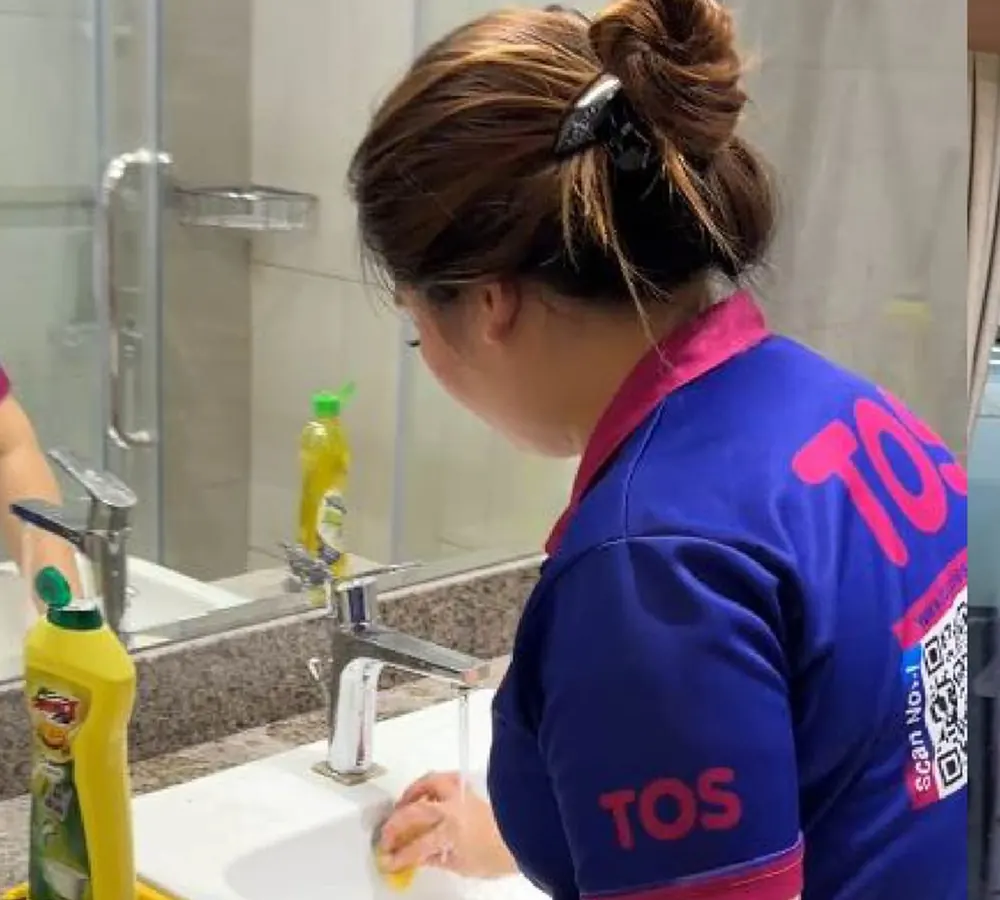 A TopOne cleaner deep cleaning a bathroom basin