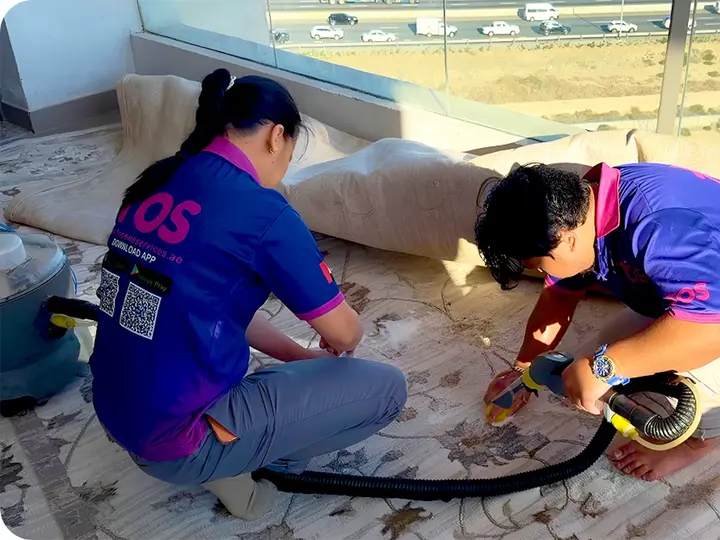 TopOne team cleaning an upholstered rug and cushions with an extraction machine