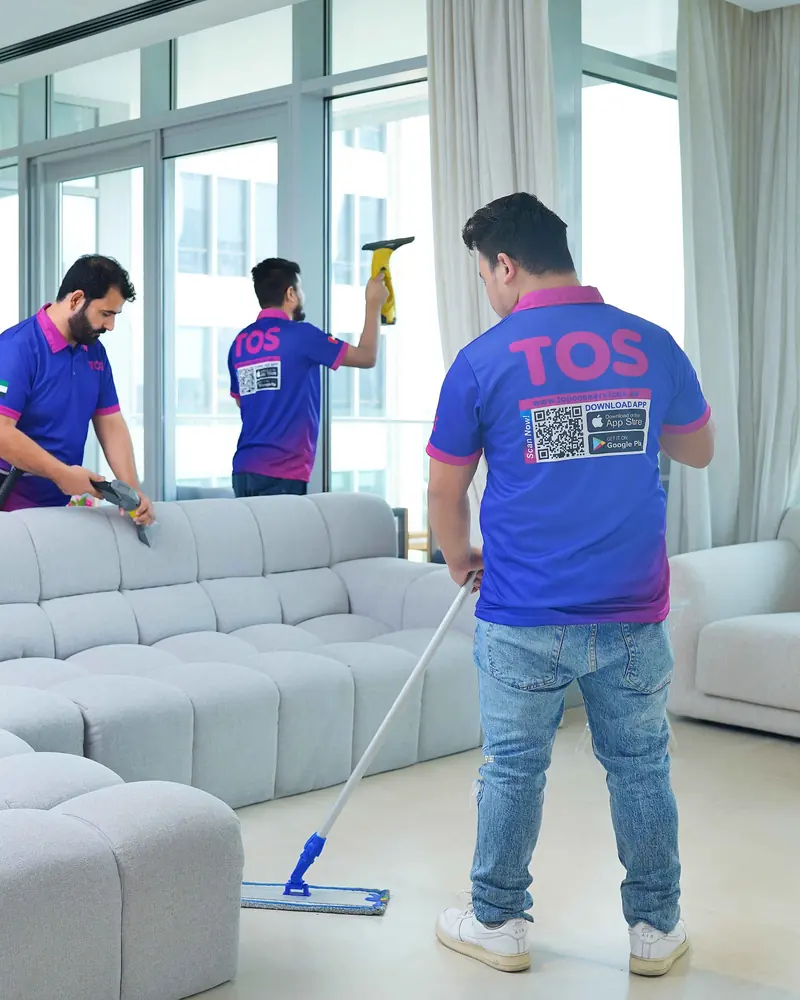 TopOne team deep cleaning a living room, mopping and wiping surfaces